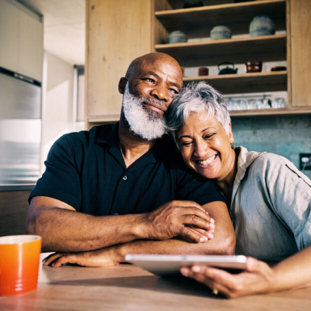 Black Couple in Kitchen looking at Tablet