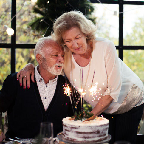 Photo of couple with cake celebrating an anniversary.